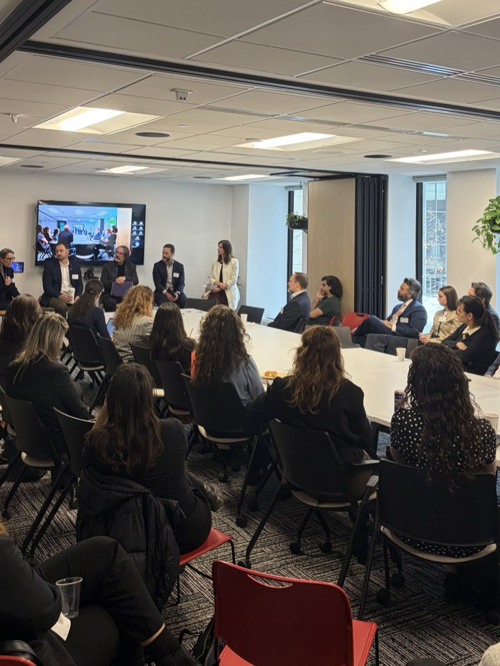 Panelists in front of attendees at the Fintech Station